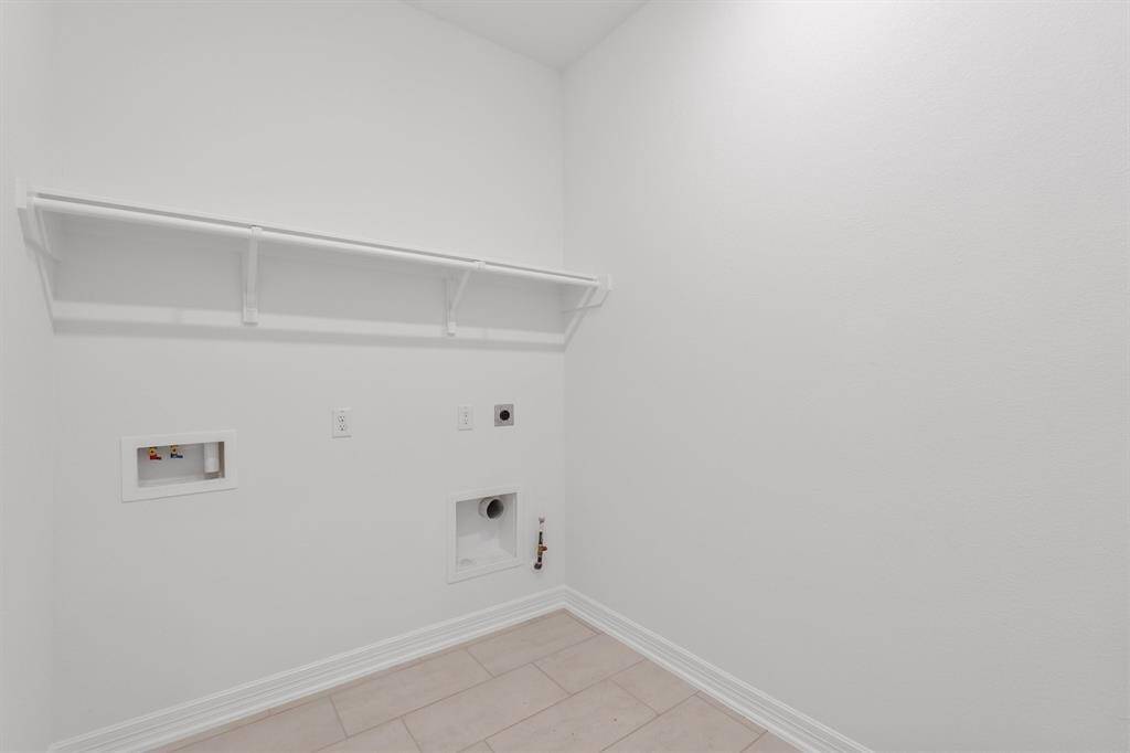 The laundry room layout is carefully planned for optimal workflow with designated areas for washing, drying, and storing.