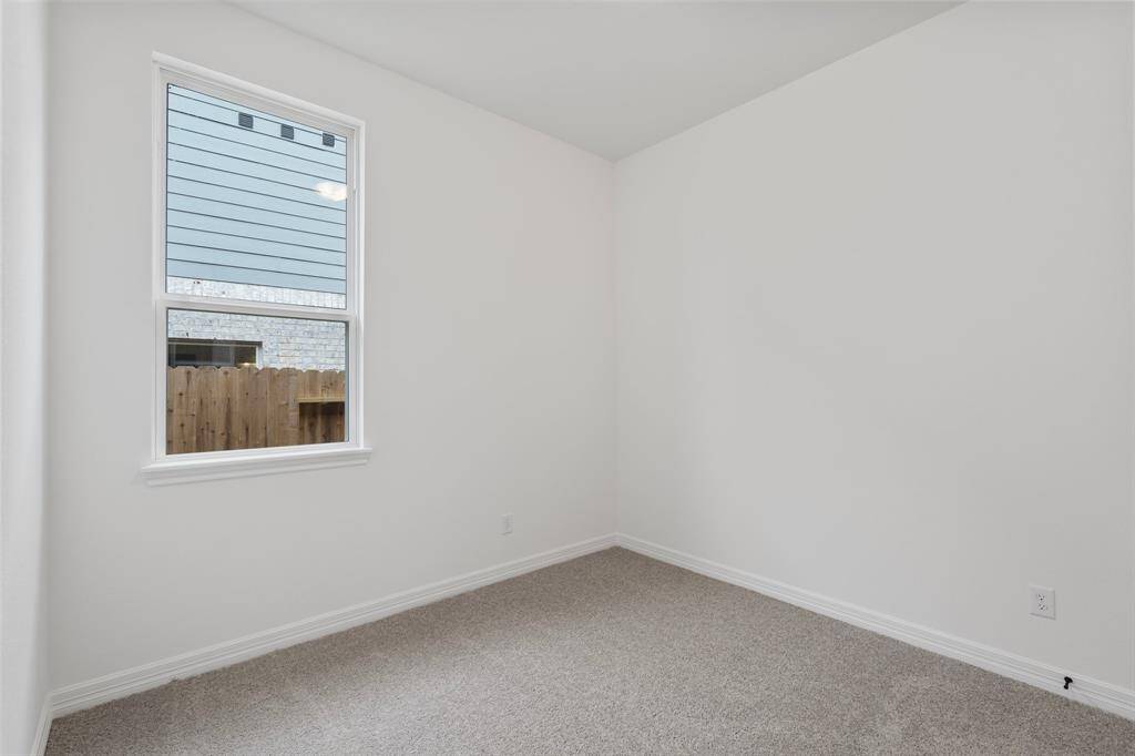 Your secondary bedroom features plush carpet, fresh paint, closet, and a large window that lets in plenty of natural lighting.