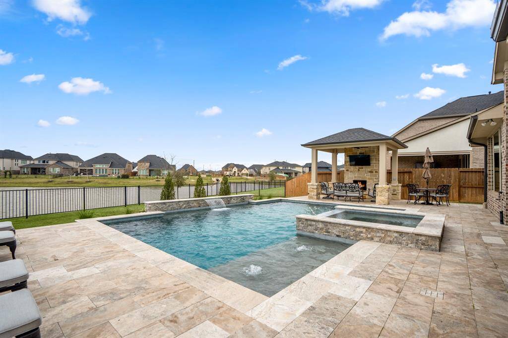 Experience lakeside luxury at its finest! You'll love spending time in the backyard! The current homeowners thought of everything when designing the ultimate backyard escape!