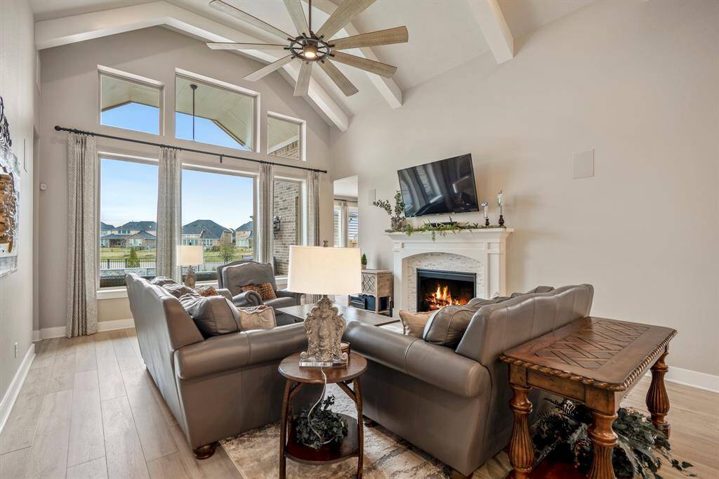 The large windows let in tons of natural light and give you a scenic view of the private backyard space.  You'll love cozying up by the fireplace, complete with modern tile surround and wood mantle.
