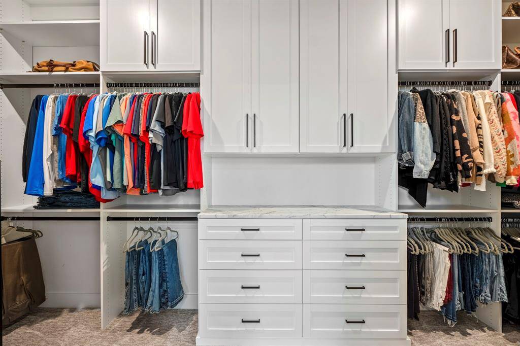 Seller's own a custom closet company and have maximized the storage space in every closet! Designed with built-ins and ample space, this walk-in sanctuary keeps everything beautifully organized while adding a touch of luxury to your daily routine.