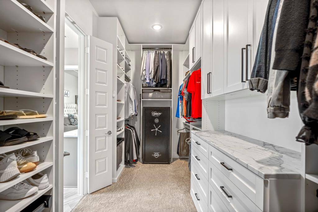 Storage meets style in this custom primary closet!