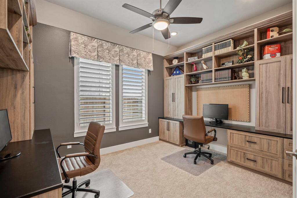 Enjoy working from home in this study! Located just off the kitchen, this office features a ceiling fan, recess lighting, upgraded carpet, and custom window coverings.