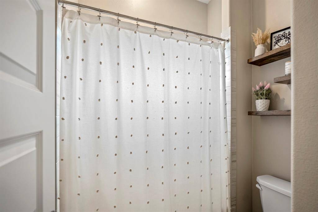 Connected to the dual vanity area off the secondary bedrooms, this large combination tub and shower makes this bathroom easy to share!