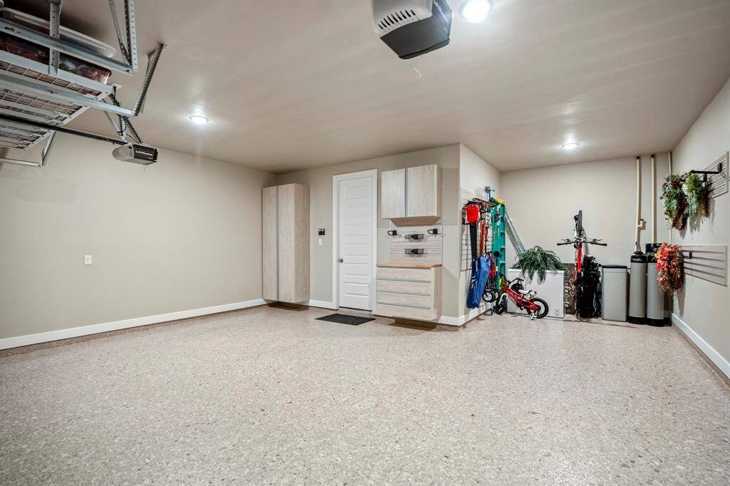 Oversized 2-car garage with epoxy floors, built-ins, and extra storage space—perfect for parking, organization, and a bit of extra room to work or store your gear.