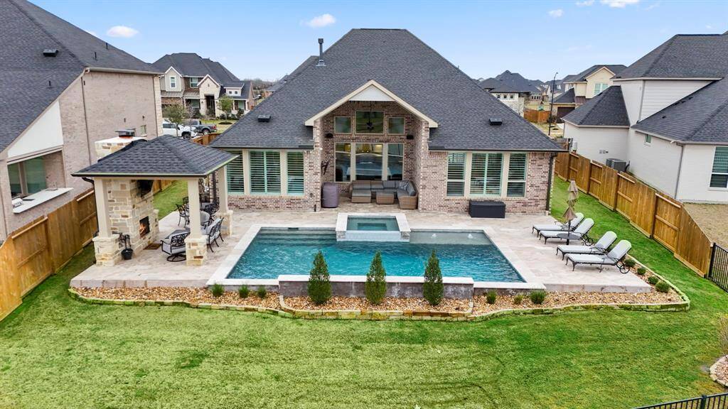The current homeowners thought of everything when designing the ultimate backyard escape! Maximizing the space the lot provided by having a pool and spa, two covered patios, a fireplace, as well as green space for any furry friends!