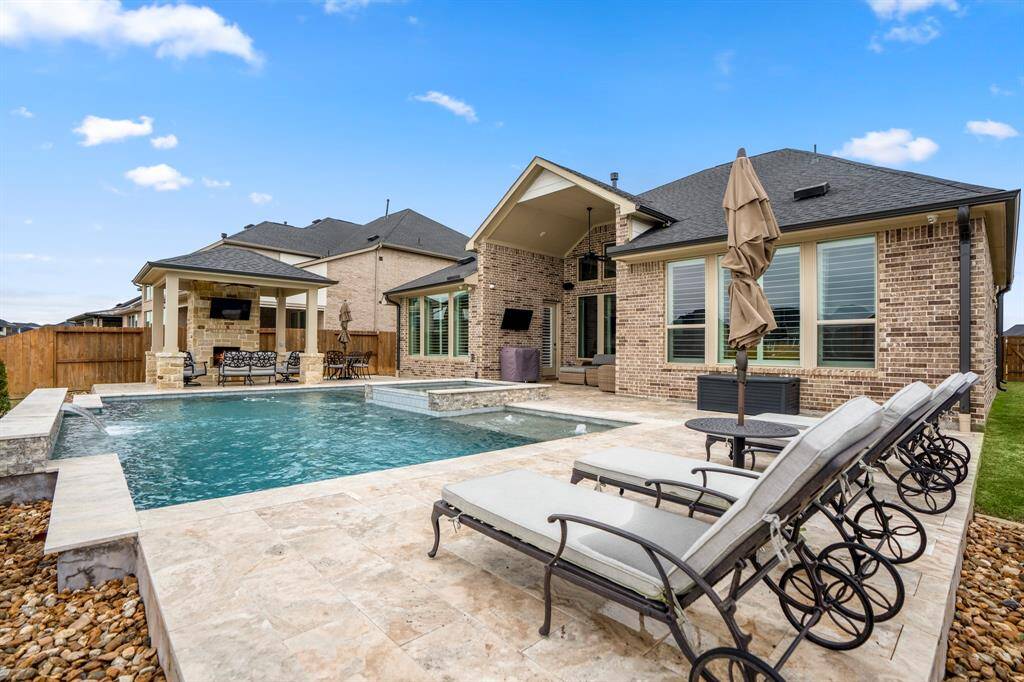 Enjoy your built-in pool to get relief from the heat! This home was built to give perfect views of the serene pool and lake from the large windows.