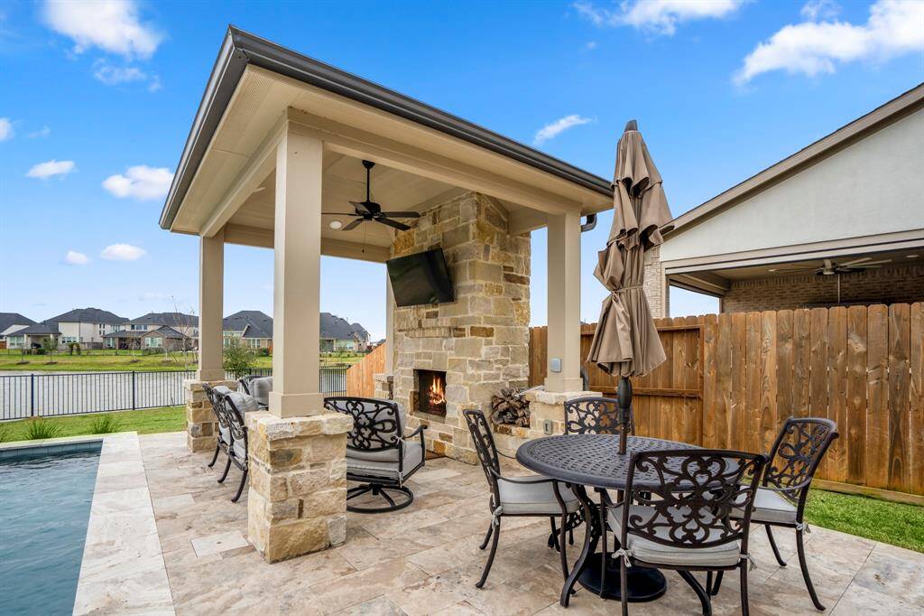 With a stone fireplace, custom travertine tile work, and outdoor ceiling fan, make this backyard one that your neighbors will envy! Speaking of neighbors, there’s none behind this house! Talk about a private backyard oasis