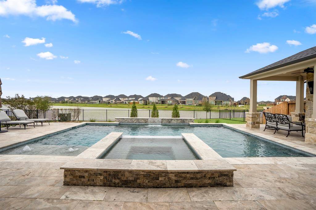 This outdoor space boasts breathtaking water views, a sparkling pool & spa, and a cozy outdoor fireplace—your private oasis awaits!