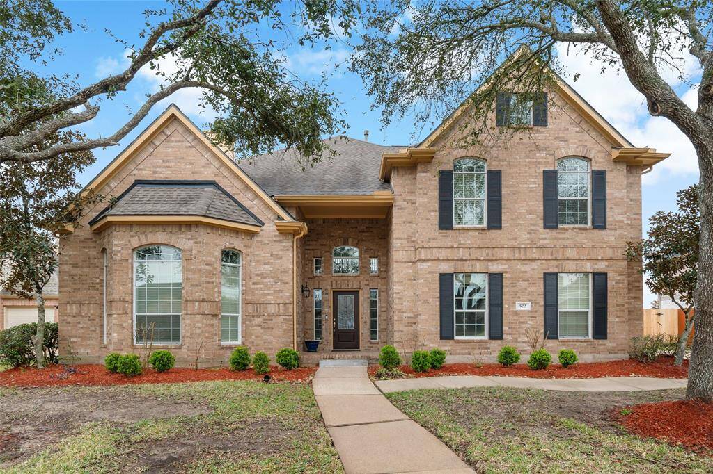 Stunning curb appeal with a charming brick facade and elegant landscaping.