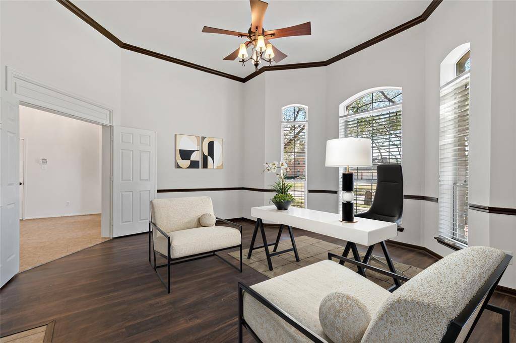 Inviting office space with elegant hardwood floors, abundant natural light from large windows, and stylish finishes—ideal for productivity and comfort.