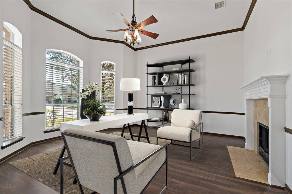 Cozy downstairs office featuring a charming fireplace.