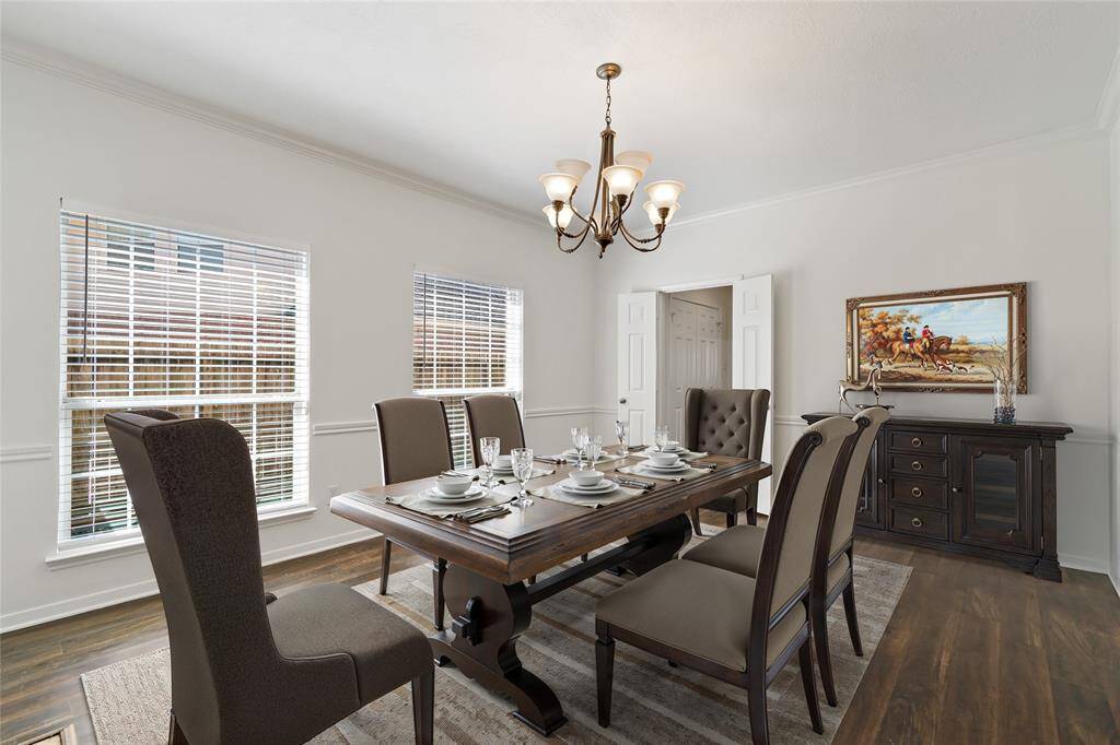 Elegant dining room featuring abundant natural light, sophisticated decor, and a welcoming atmosphere perfect for gatherings.