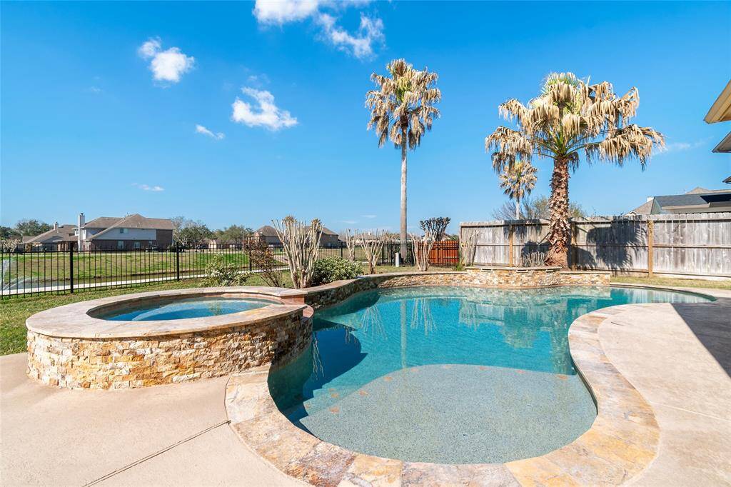 Enjoy serene water views from your luxurious pool and spa.