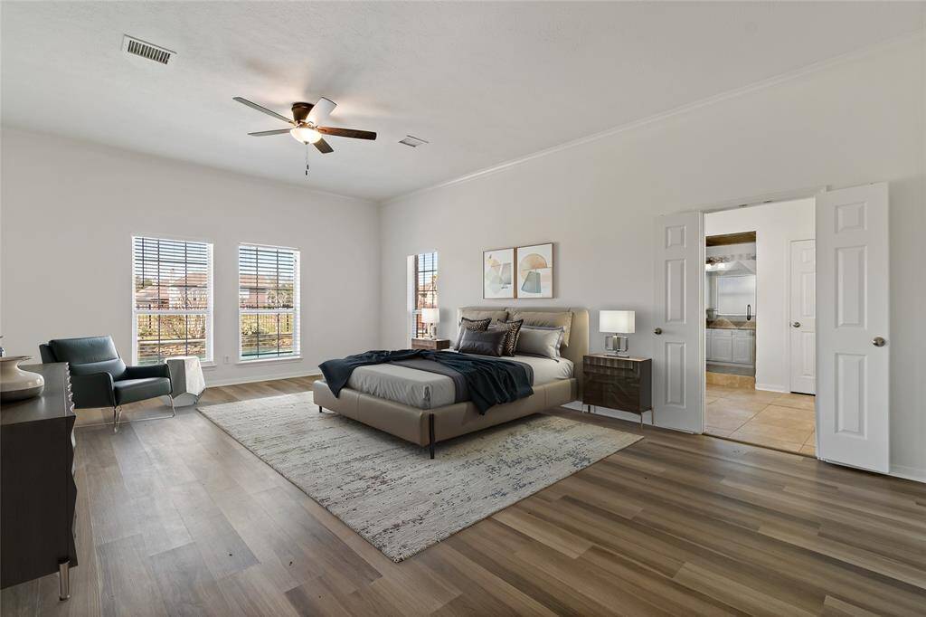 Luxurious primary suite with abundant natural light, elegant flooring, and a spacious layout. Enjoy the seamless flow into a modern en-suite bathroom for ultimate comfort.