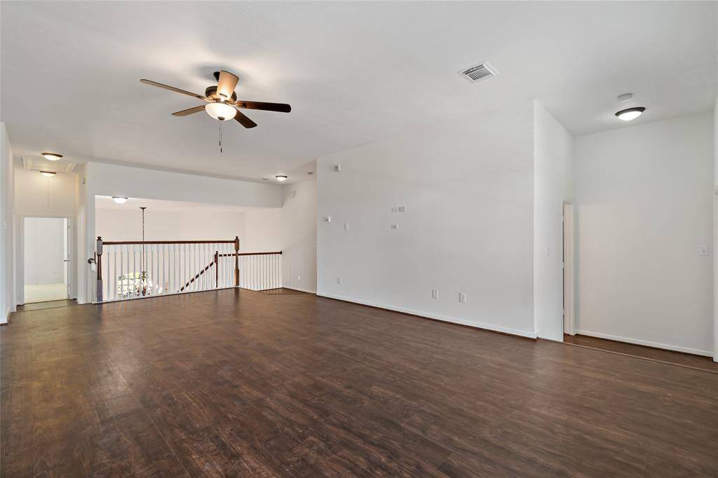 Expansive upstairs game room perfect for entertainment and relaxation.