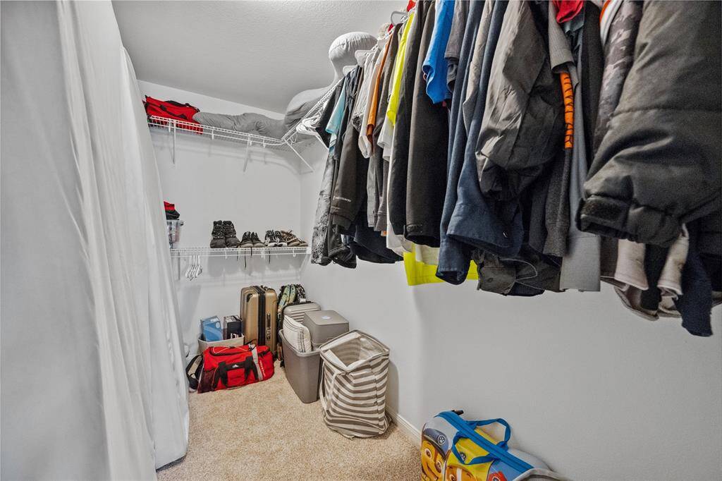 1 of 2 walkin closets in primary bedroom