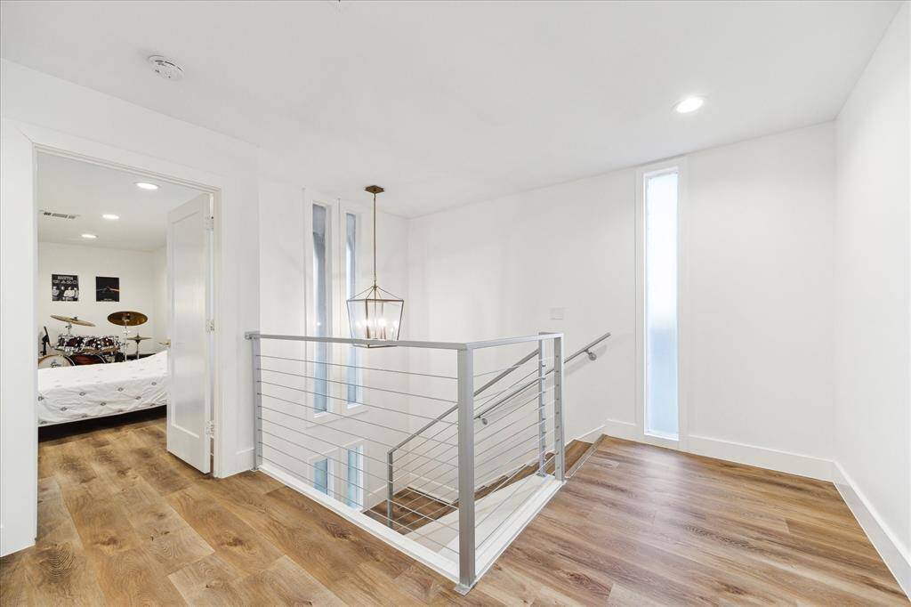 The second-floor features four inviting suites, including two luxurious primary suites (one with a balcony) and a convenient utility room.