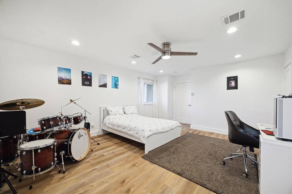 Your guests will rest comfortably in this spacious suite with luxury vinyl plank flooring, neutral paint, a raised ceiling with recessed lights and a modern lit fan, a large walk-in closet, and a beautifully updated ensuite bathroom.