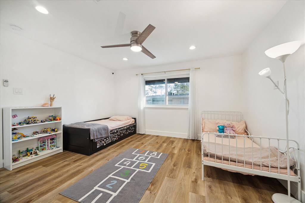 This fabulous home has four very spacious suites, all are located upstairs. This welcoming suite offers LVP flooring, neutral paint, recessed lights and a modern lit fan, a large walk-in closet, and ensuite access to an updated bathroom.