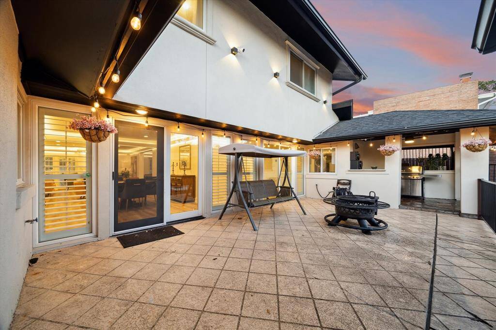 A covered summer kitchen makes outdoor entertaining a snap while leaving plenty of space for outdoor dining and lounging.