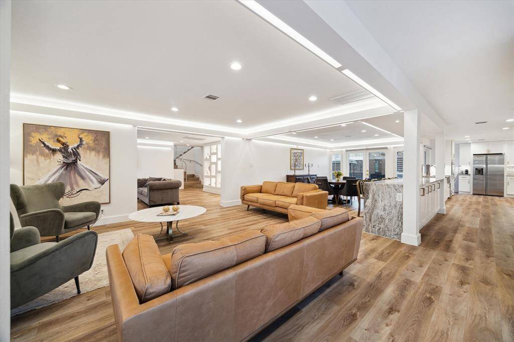 Step into contemporary elegance with LVP flooring and ambient lighting. The open-concept design seamlessly connects the family room, den, and dining area, offering the perfect blend of comfort and sophistication for both relaxed daily living and effortless entertaining.