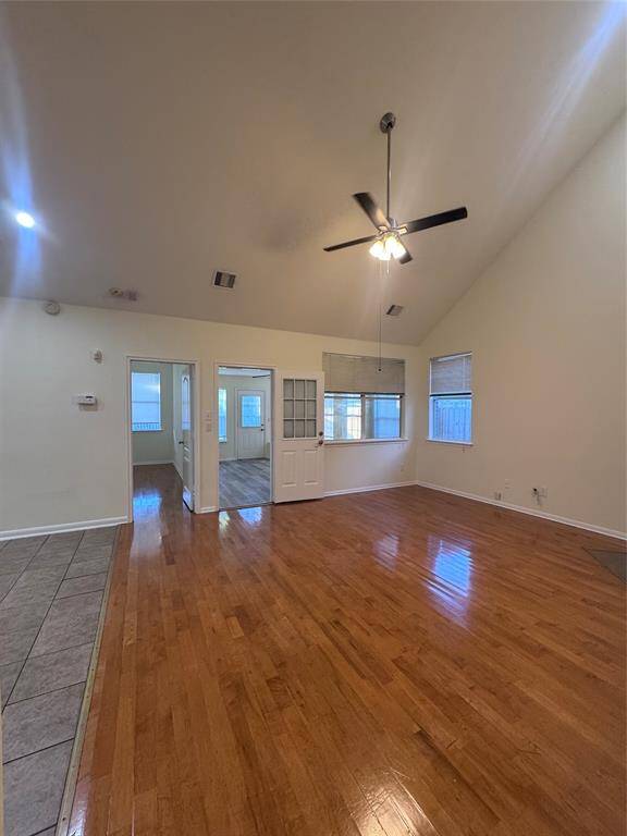 High ceiling living room with fan and fireplace