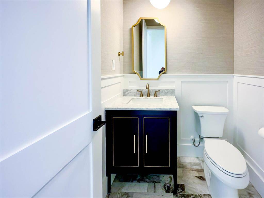 Powder room with luxury vanity & wallpaper