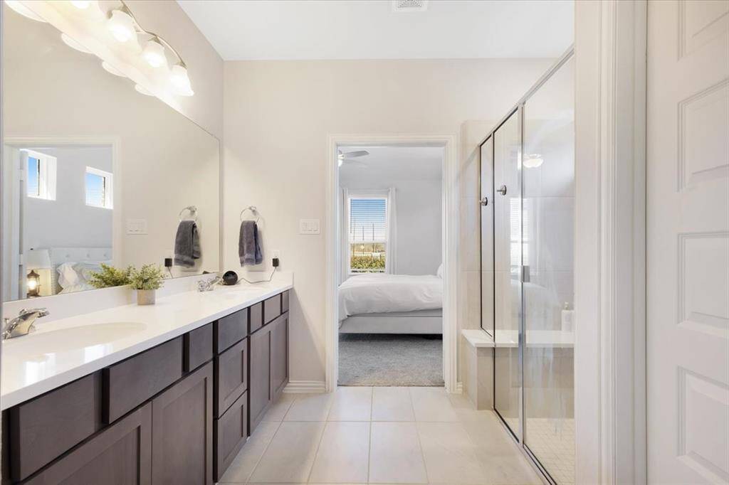 Ensuite primary bathroom with double sinks and a large walk-in shower