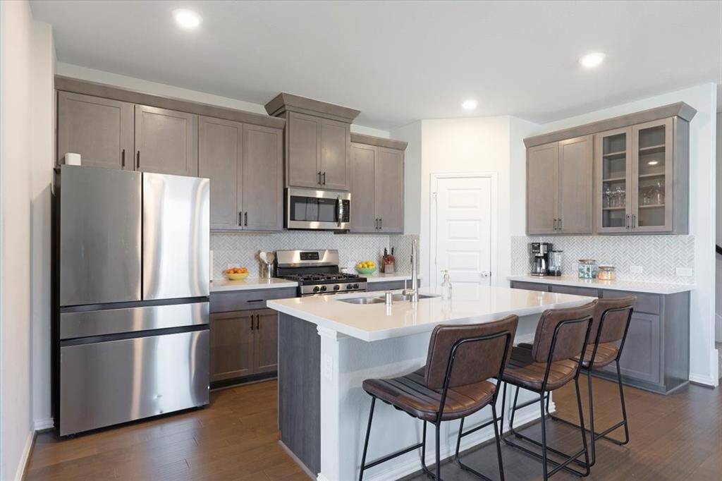 Stylish kitchen with island. Fridge, washer & dryer stay with the home!