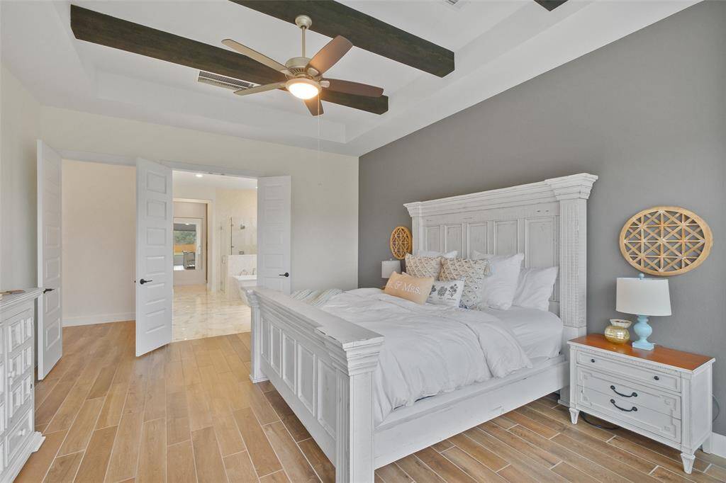 The Primary Bedroom is simply serene and scenic, overlooking the property.