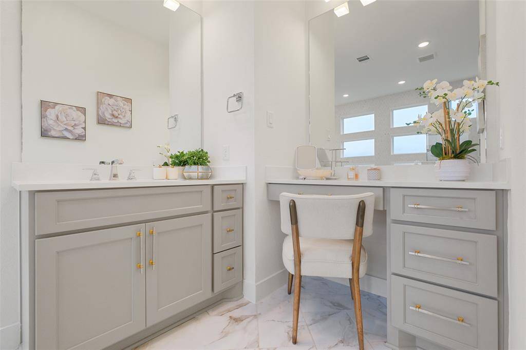 Frameless double shower with his and her sprayers, bench seat and storage niches.