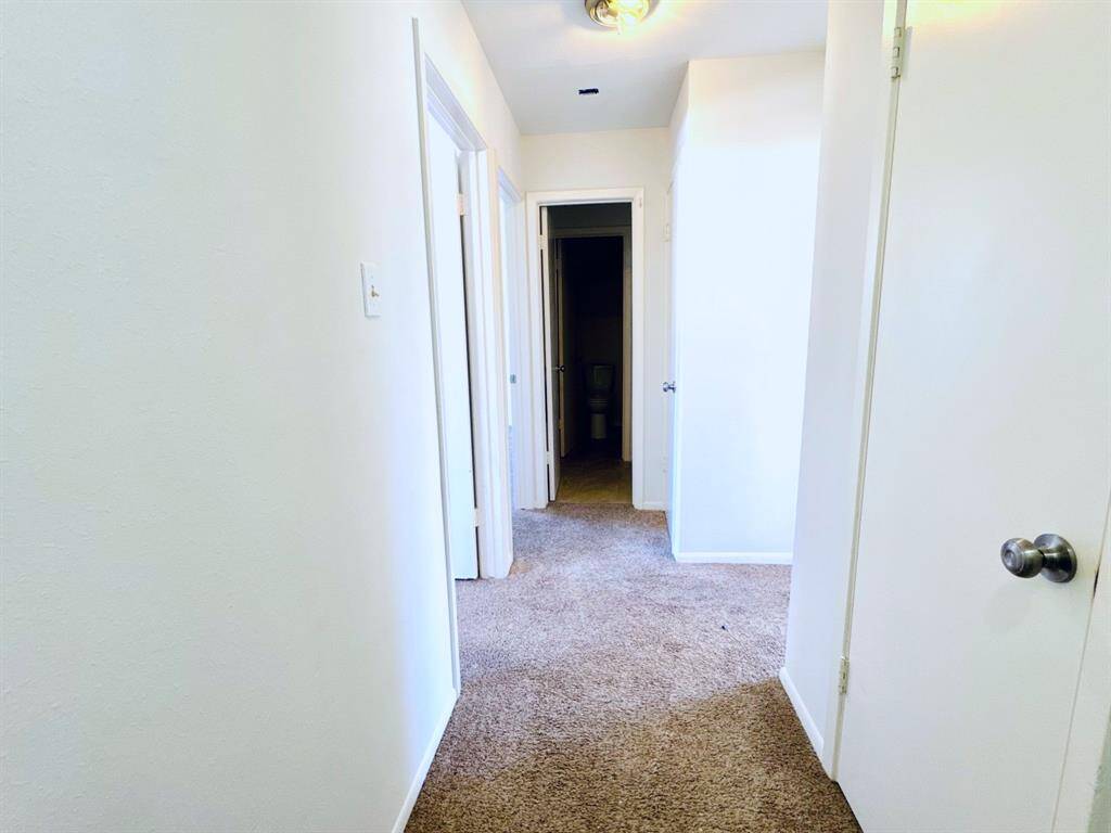 A well-lit hallway that offers easy access to multiple rooms, enhancing the home’s functional layout.