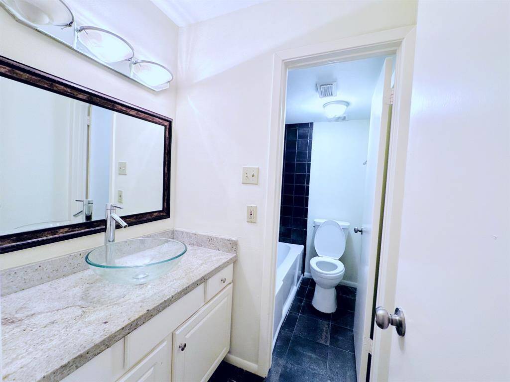 A sleek and modern bathroom with stylish finishes, leading to a well-lit hallway that connects to the rest of the home.