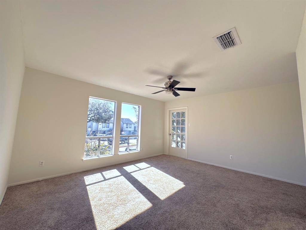 A bright and open living area with oversized windows, flooding the space with natural light.