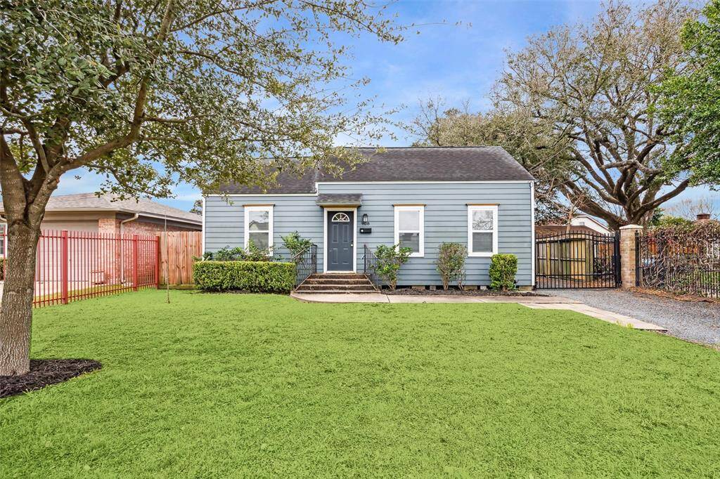 Charming single-story home with a neatly landscaped front yard and mature trees. Features a welcoming front porch, a gated driveway, and a fenced backyard, offering both privacy and curb appeal.