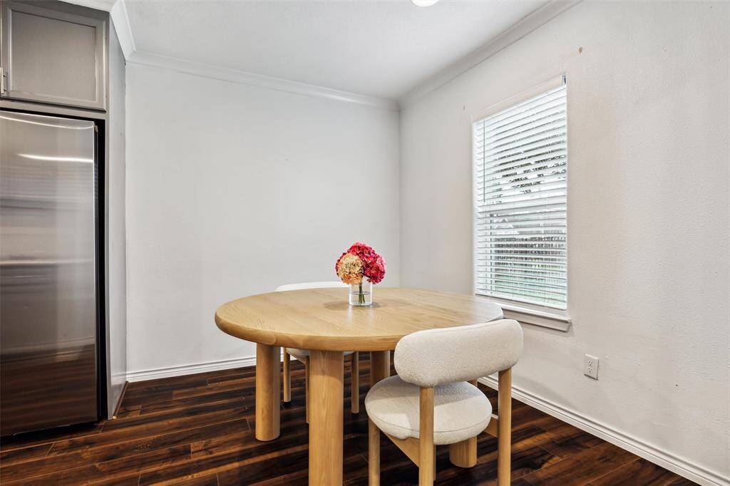 This cozy breakfast room has a backdrop of subtle walls and a window that lets in and abundance of natural light.