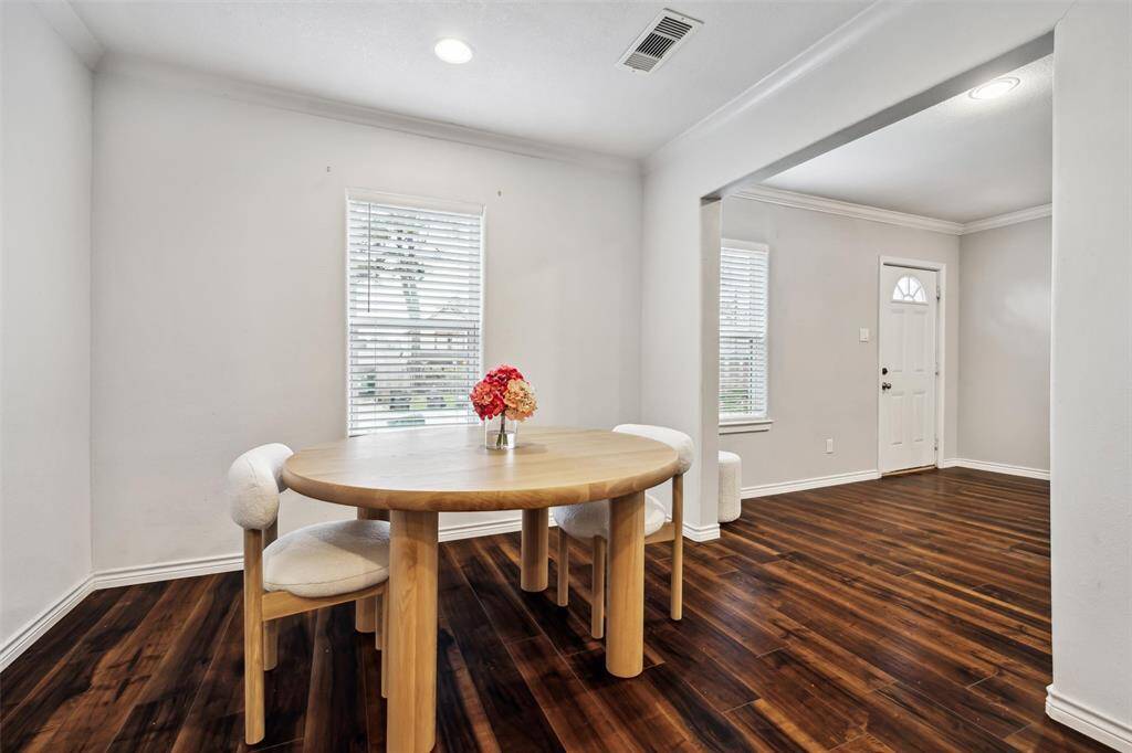 This photo showcases how the bright breakfast room opens to the living area.