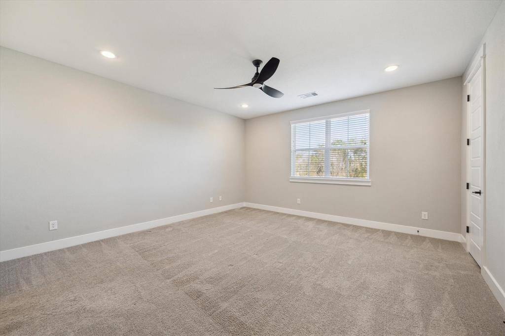 Private Primary Suite on the Third Floor with Can Lighting, Ceiling Fan, Plush Carpet, and Natural Light.
