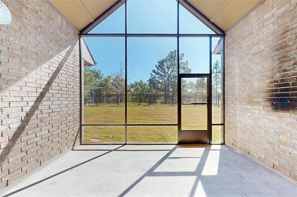 Enclosed back patio, perfect for entertaining or enjoying rainy days outside!