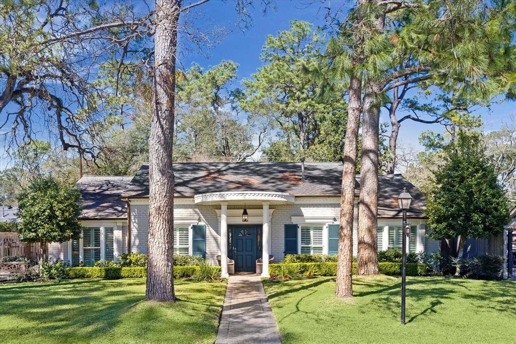 Charming 4 bedroom, 3 bath 1.5 story home features a manicured lawn and a gated double wide driveway leading to the detached garage.