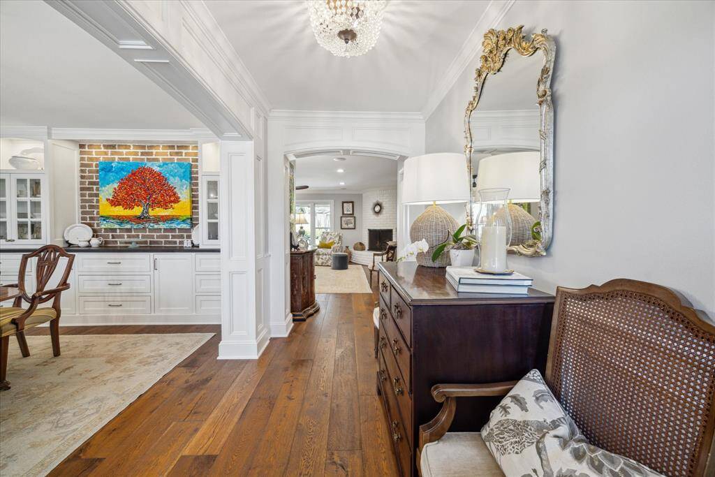 The inviting entry showcases a bright hallway leading to the formal dining room and the spacious living area.