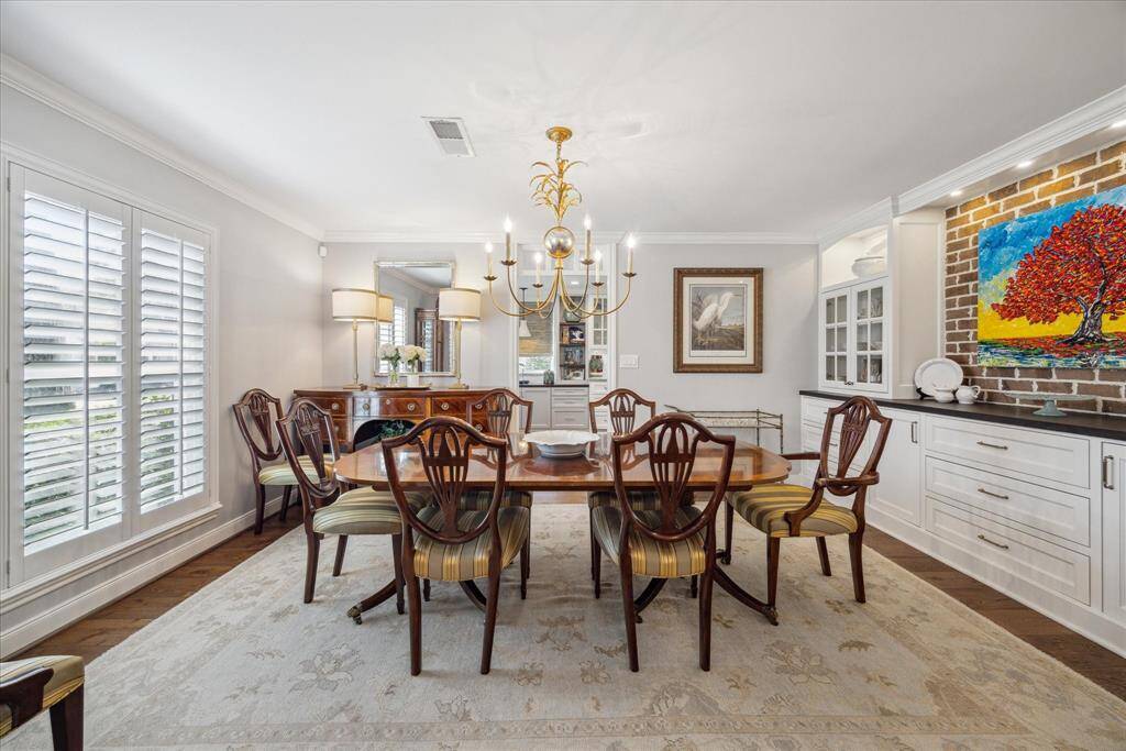 The dining room has great natural light from the shuttered windows and is perfect for intimate dinners or large  gatherings.