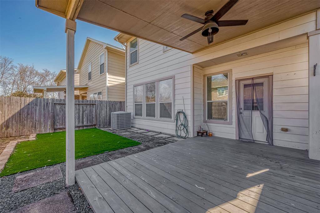 This covered patio extends the living space outdoors, complete with a ceiling fan to keep things comfortable on warm days.