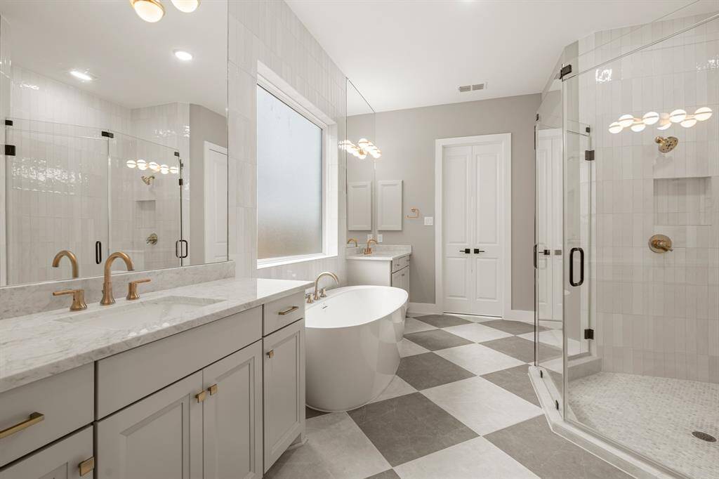 SPA BATH TO RELAX AND UNWIND - SEPARATE SHOWER AND MODERN FREESTANDING TUB - DUAL MARBLE VANITIES - DESIGNER FINISHES WITH POPS OF GOLD FOR A LUXURIOUS TOUCH