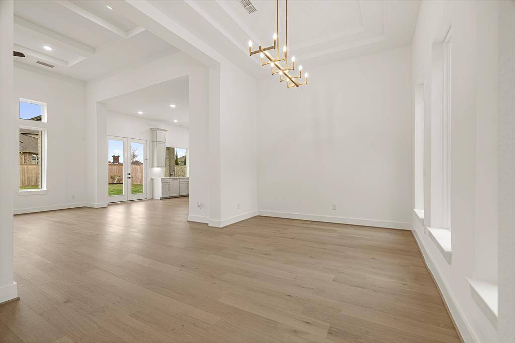 EXPANSIVE FAMILY ROOM WITH STACKED WALL OF WINDOWS - OPEN TO KITCHEN - HIGH CEILINGS