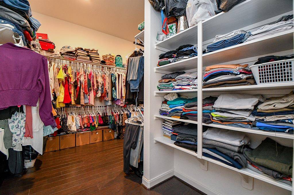 This primary closet wraps around with a lot of space