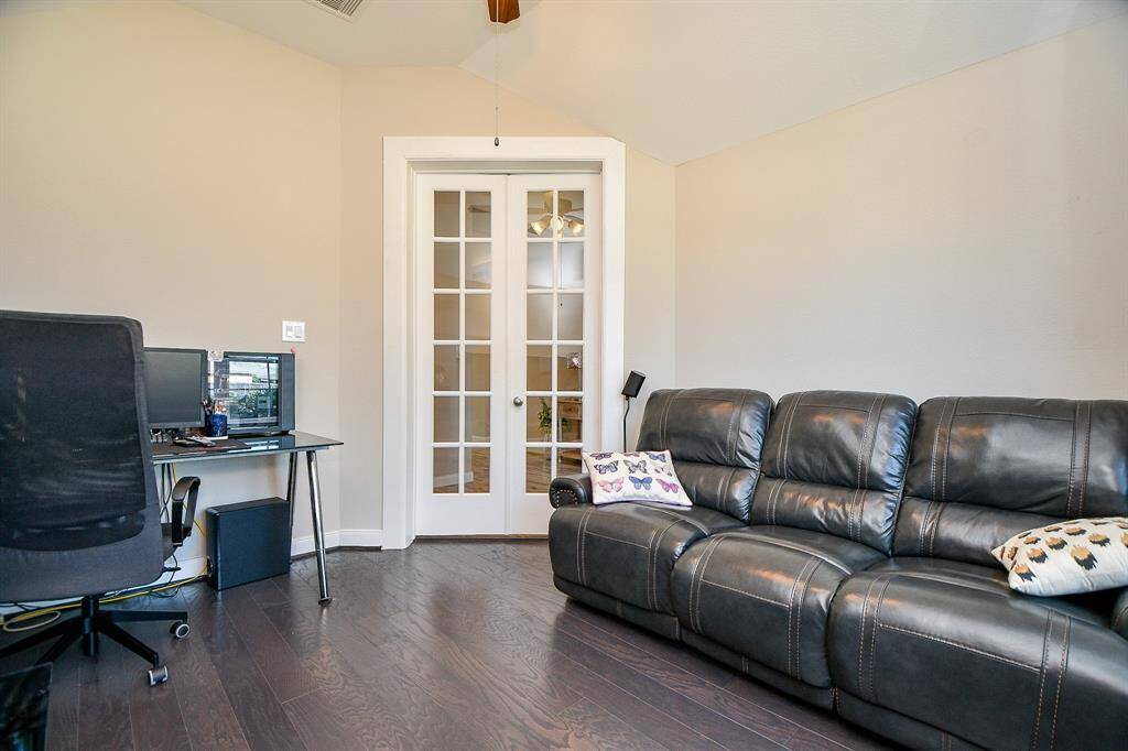 Just off the front foyer, these double french doors lead you into a perfect study or office area with wood flooring
