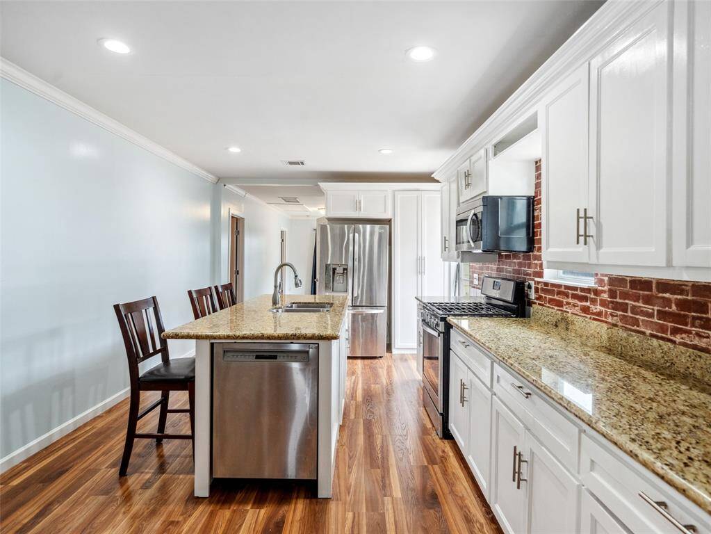 Updated kitchen featuring a center island, breakfast bar.