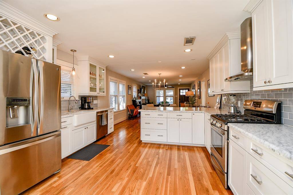 The kitchen is nicely appointed with marble counters, stainless steel appliances, a farmhouse sink and a nice amount of storage.